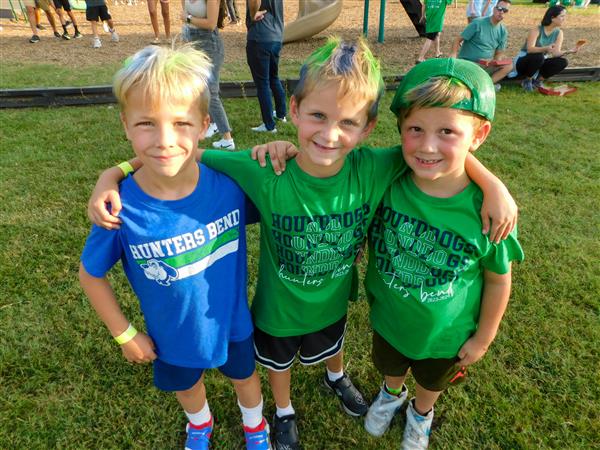 Students outside enjoying a family fun night for their school.